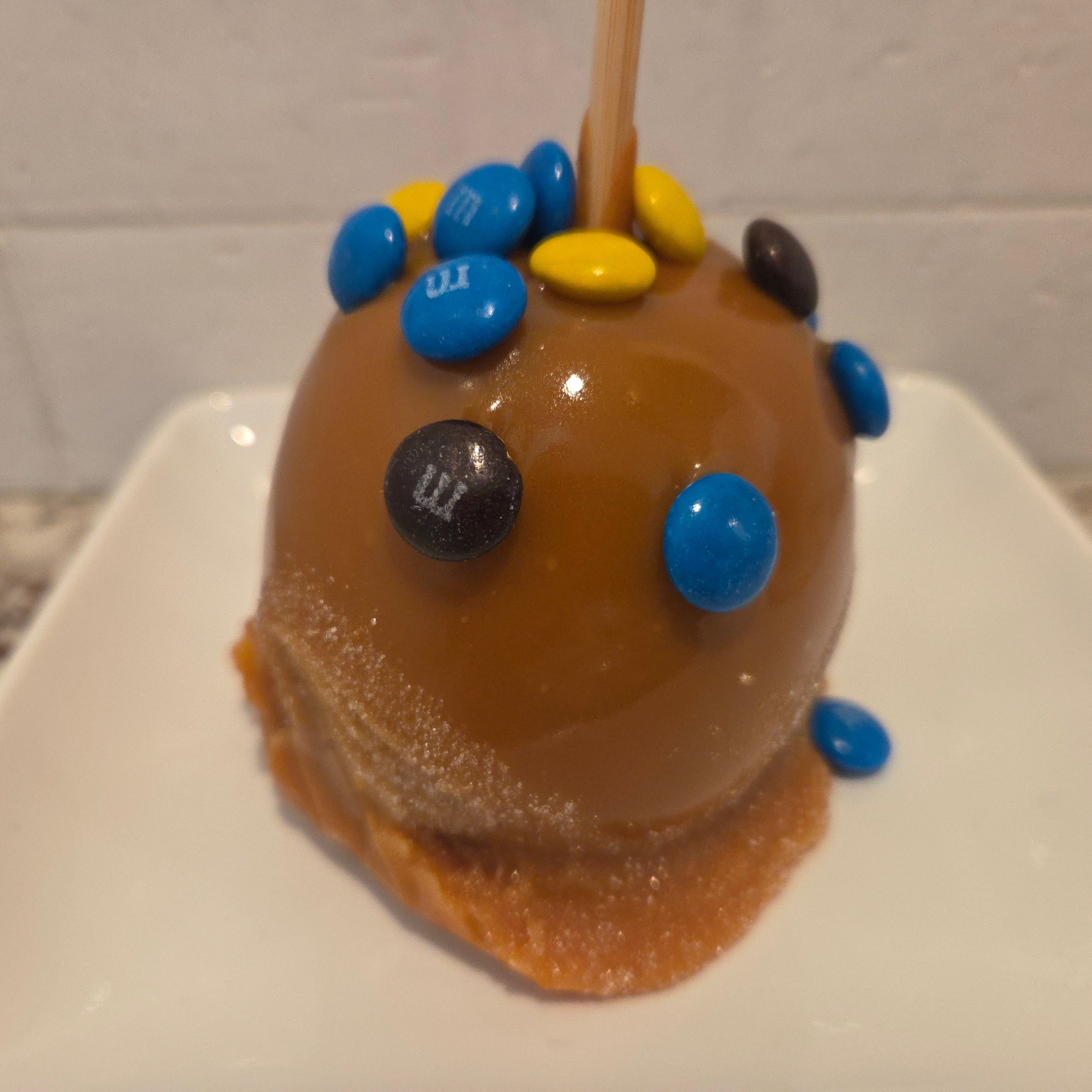 Traditional Caramel Apple covered in colorful M&M's